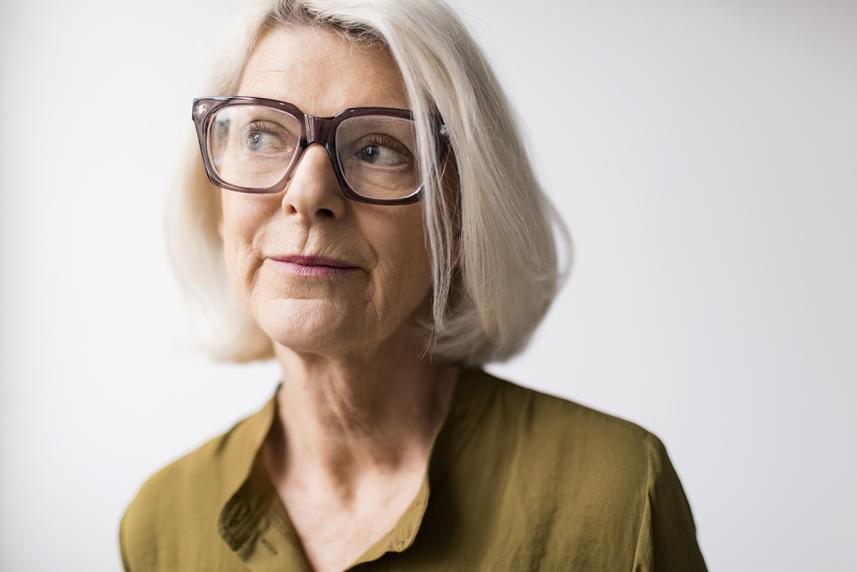 Woman with glasses looking ahead