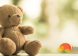 A brown teddy bear sitting on top of a table