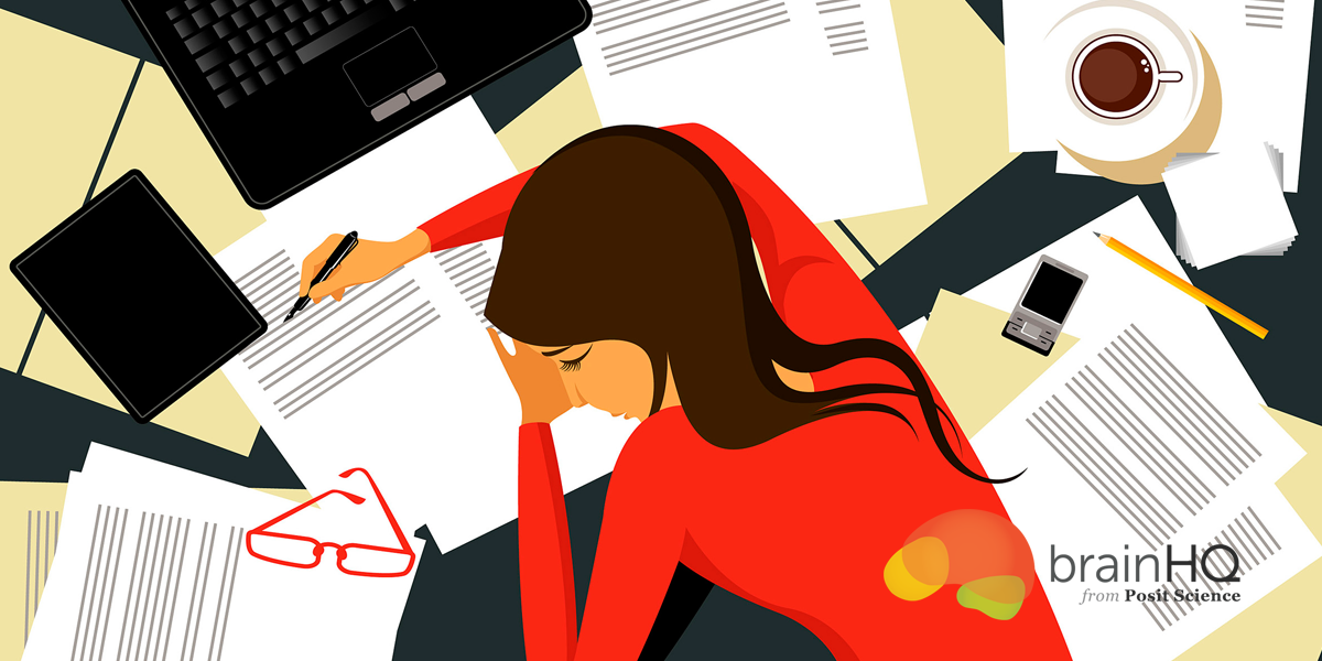 stress-1200×600-1 A woman sitting at a desk with papers and a laptop
