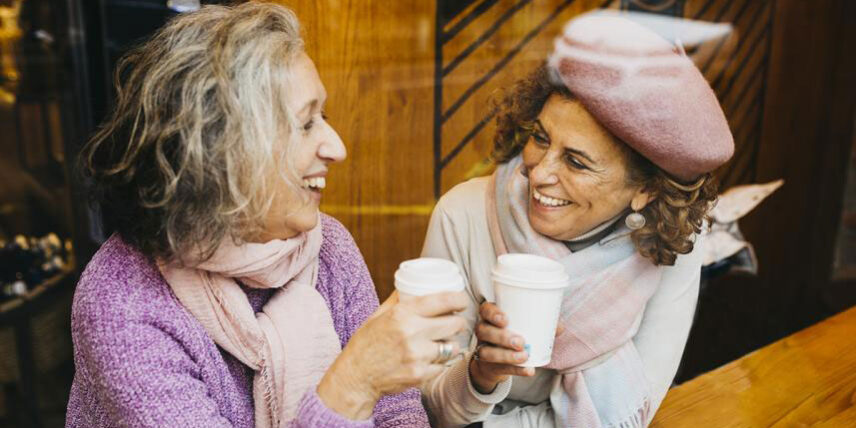 B3_BrainBetter Two women sitting at a table talking to each other
