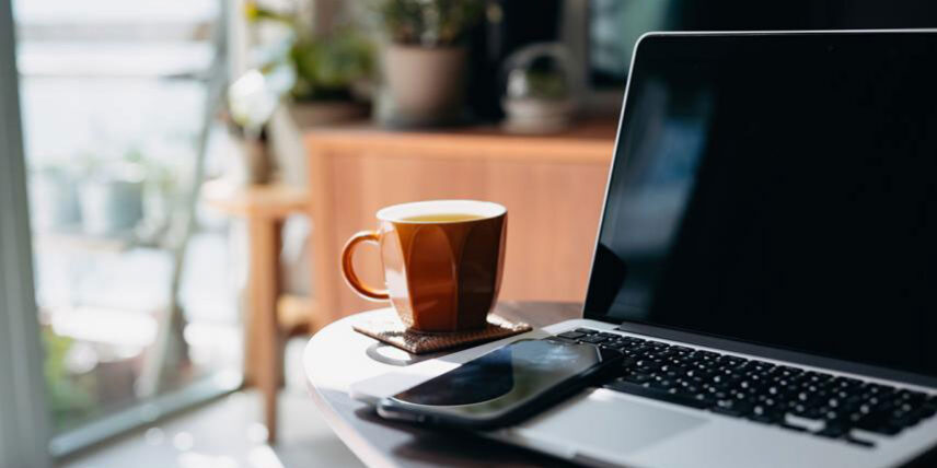 BurningQs A laptop computer sitting on top of a wooden table