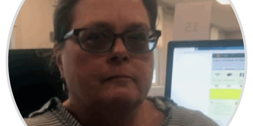 melissa-d A woman with glasses is looking at a computer screen