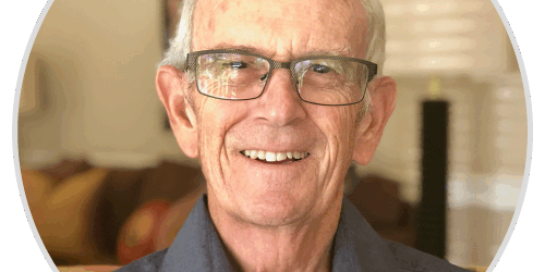 stories-johno An older man wearing glasses and a blue shirt