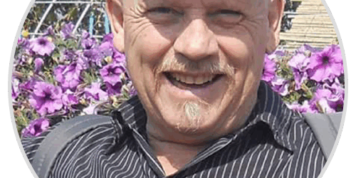 stories-mike A man with a white hat is smiling