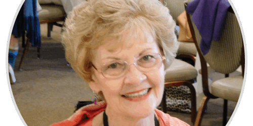 stories-penelope A woman with glasses smiling for a picture