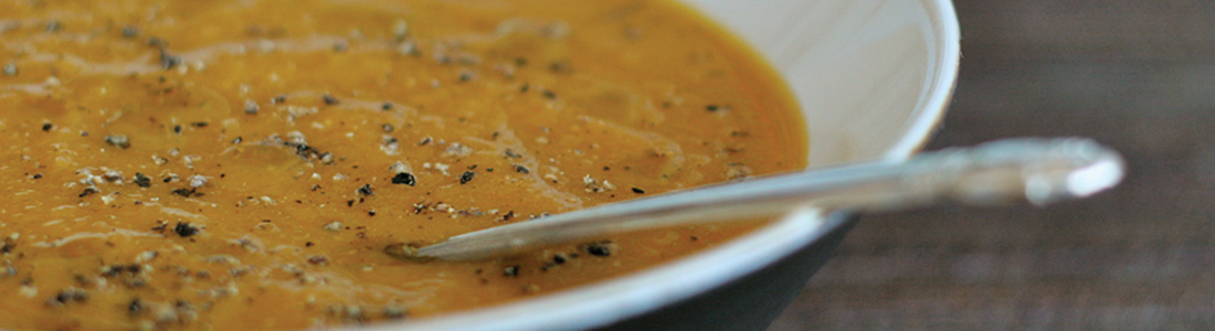 A bowl of soup with a spoon in it