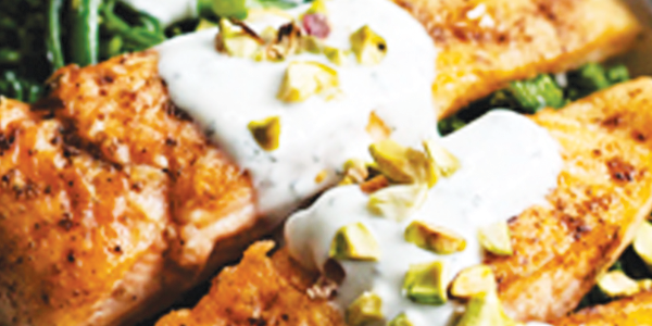 A white plate topped with fish and asparagus