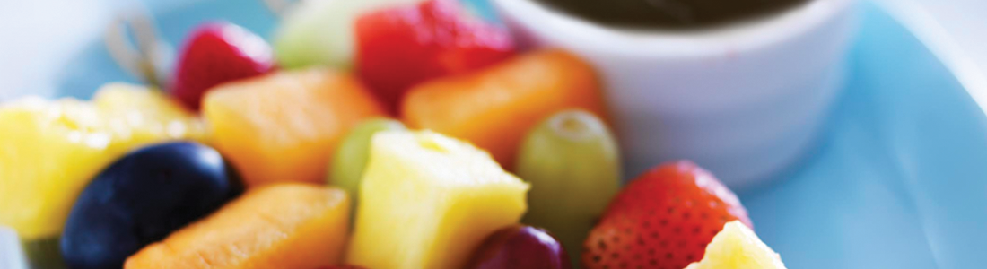 A close up of a plate of fruit on a table