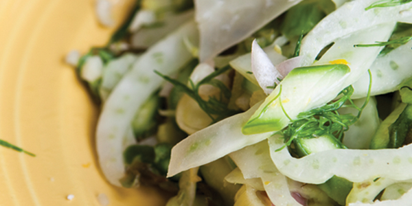 fennel A yellow plate topped with a salad and a fork