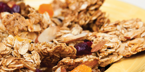 granola A yellow plate topped with granola and fruit