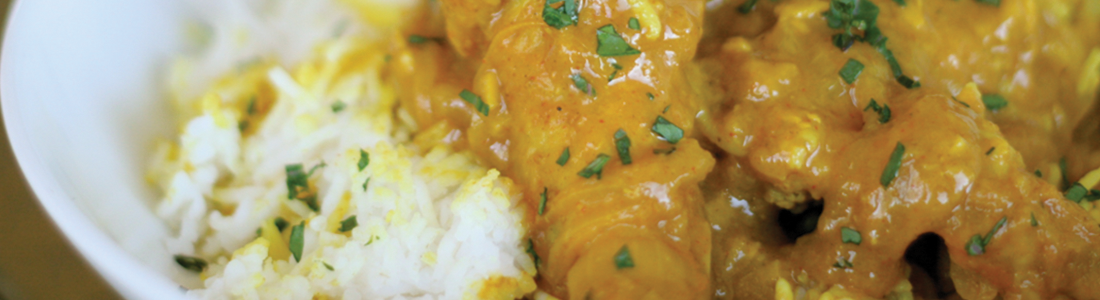 A close up of a plate of food with chicken and rice