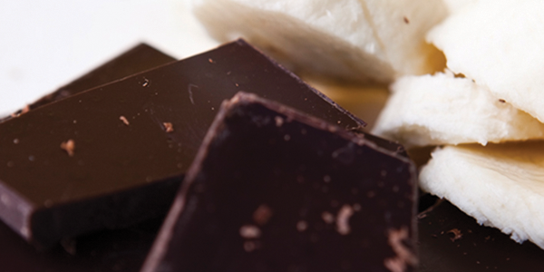 A close up of a pile of chocolate and bananas