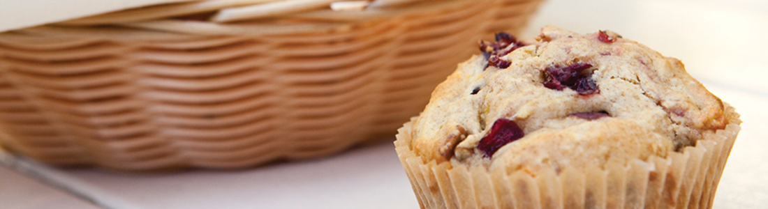 A close up of a muffin near a basket
