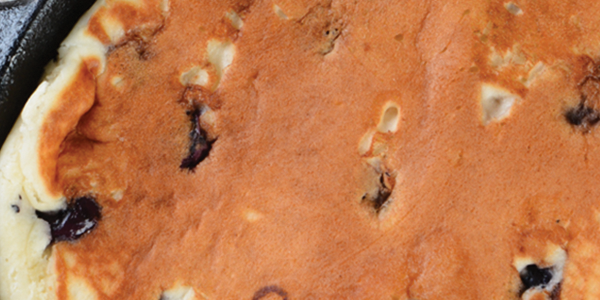 pancakes_0 A pan filled with food sitting on top of a table