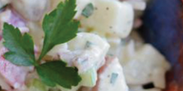 potato-salad_0 A blue bowl filled with food on top of a wooden table