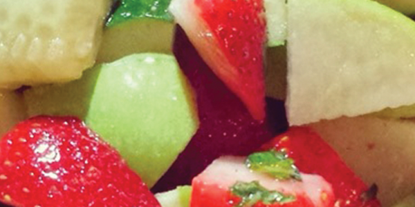 strawcucum A close up of a fruit salad in a bowl