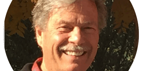 testimonials-jeffb A man with a moustache smiles for the camera