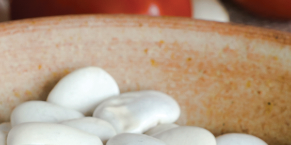 tomato_0 A wooden bowl filled with mushrooms on top of a table