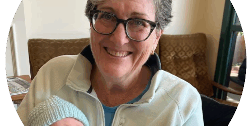 testimonials-debbie A woman holding a baby in her arms