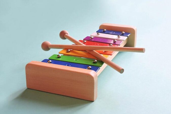 A wooden xylons set up on a blue surface