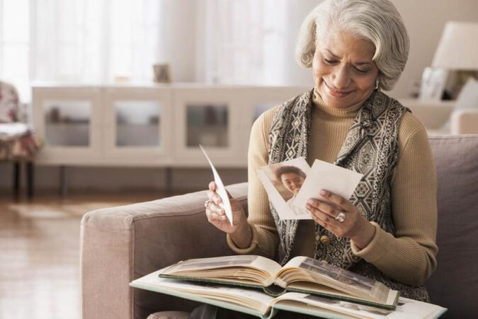 A woman sitting on a couch reading a book