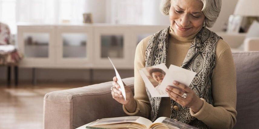TypesMemory_182657415_5 A woman sitting on a couch reading a book