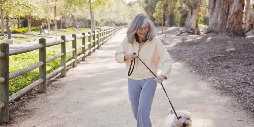 B1_WorkoutMotivation_145062562_24 A woman walking a dog on a leash