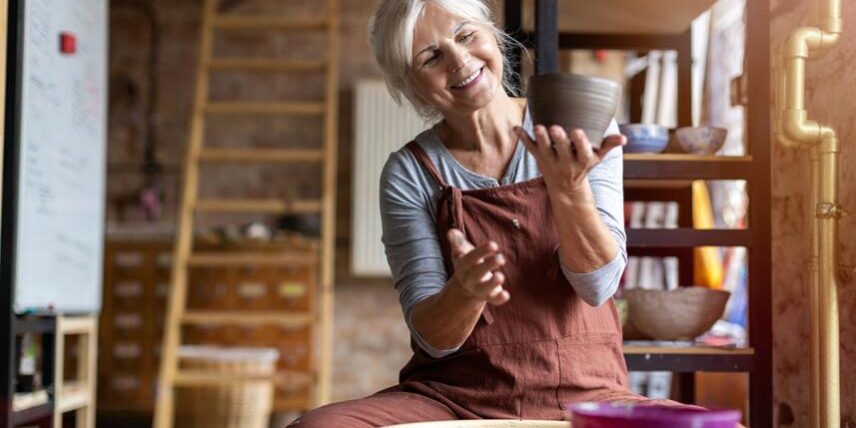 B2_LearningAfter65_1187877458_15 A woman sitting on a stool holding a cup