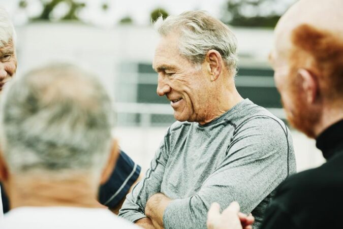 A group of older men standing next to each other