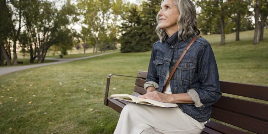 B5_Nature_1442272253_7 A woman sitting on a bench reading a book