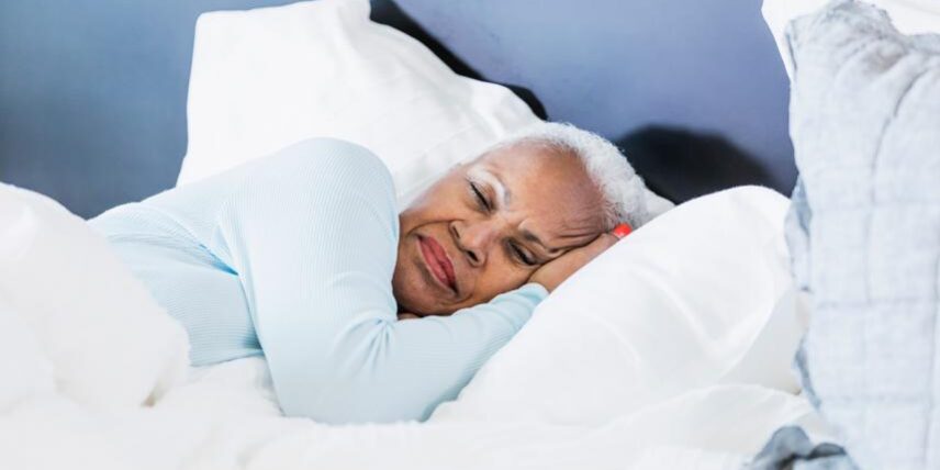 PS_Napping-1172340398_1 A woman laying in bed with her head on the pillow