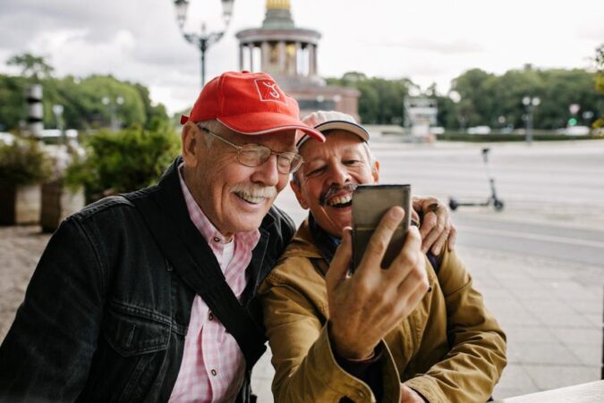 A man taking a selfie with another man