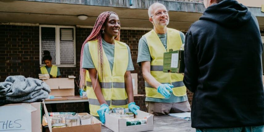 PS_Volunteering-1368958493_4 A group of people standing around a table