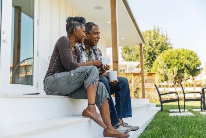 A man and a woman sitting on a porch