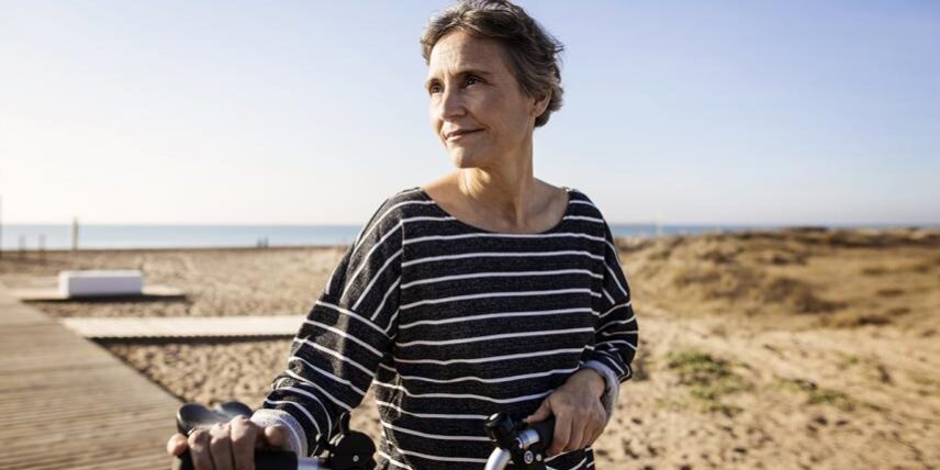A woman riding a bike on a beach